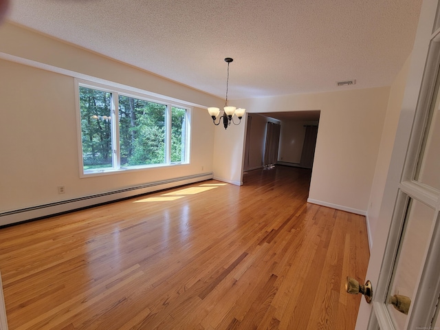 12 Enrico Rd, Bolton, CT 06043 - unfurnished dining area featuring a chandelier, a textured ceiling, light wood-type flooring, and baseboard heating