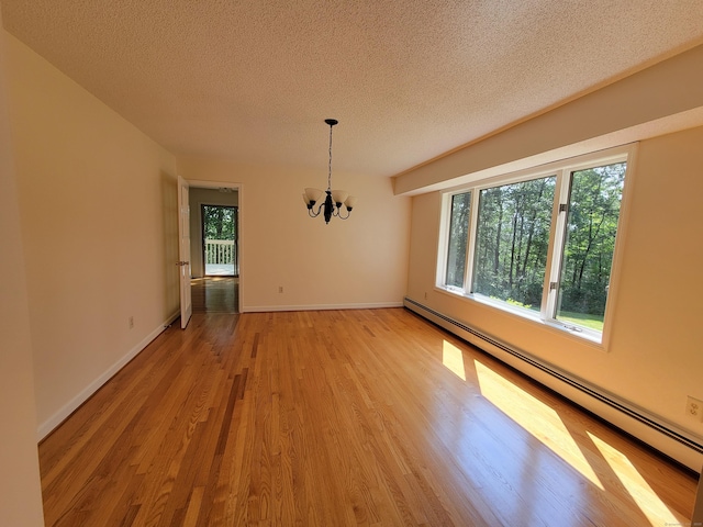 12 Enrico Rd, Bolton, CT 06043 - unfurnished dining area featuring a baseboard radiator, a chandelier, a textured ceiling, and light wood-type flooring