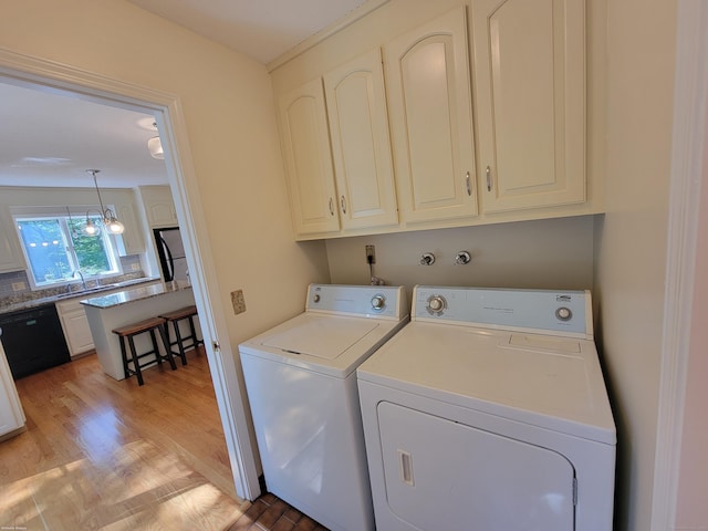 12 Enrico Rd, Bolton, CT 06043 - washroom featuring cabinet space, washer and clothes dryer, and light wood-style floors