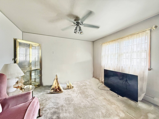 living room with a ceiling fan and carpet flooring