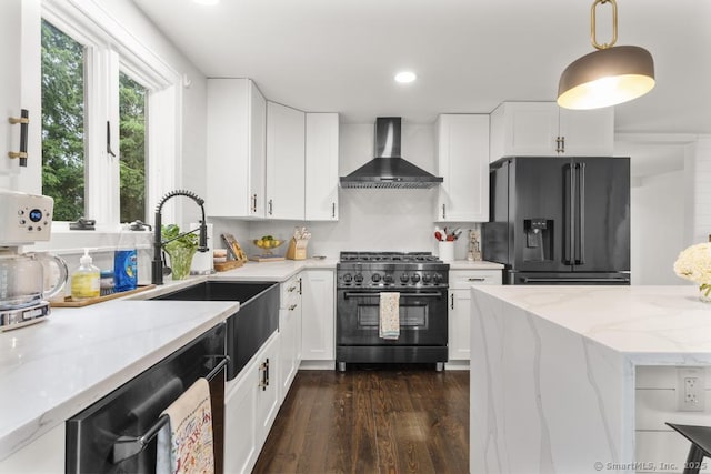 1207 Stillson Rd, Fairfield, CT 06824 - kitchen featuring black fridge, stainless steel range, wall chimney range hood, light stone counters, and dishwasher