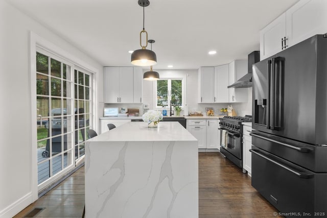 1207 Stillson Rd, Fairfield, CT 06824 - kitchen with high quality appliances, recessed lighting, dark wood finished floors, light stone counters, and wall chimney exhaust hood