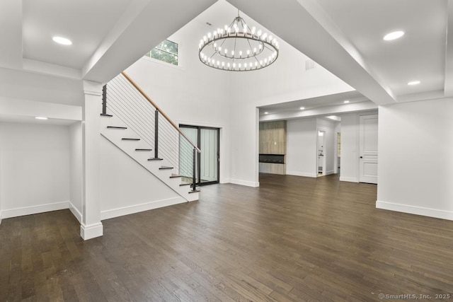 1207 Stillson Rd, Fairfield, CT 06824 - unfurnished living room with a chandelier, wood finished floors, stairs, recessed lighting, and a towering ceiling