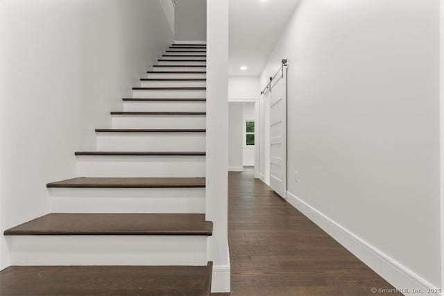 1207 Stillson Rd, Fairfield, CT 06824 - stairway featuring a barn door, recessed lighting, and wood finished floors