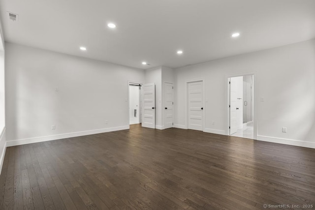 1207 Stillson Rd, Fairfield, CT 06824 - unfurnished living room featuring dark wood-style floors, a barn door, and recessed lighting