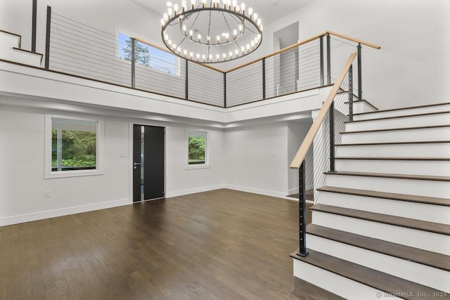 1207 Stillson Rd, Fairfield, CT 06824 - foyer featuring a towering ceiling, wood finished floors, a chandelier, and stairway