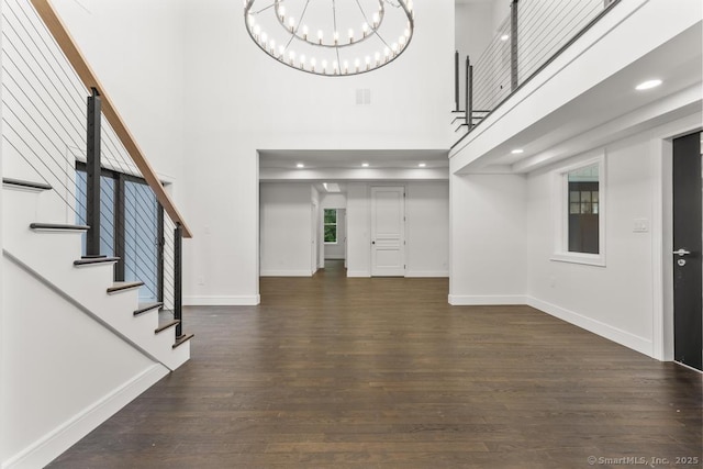 1207 Stillson Rd, Fairfield, CT 06824 - foyer entrance featuring a towering ceiling, a chandelier, dark wood-style floors, stairs, and recessed lighting