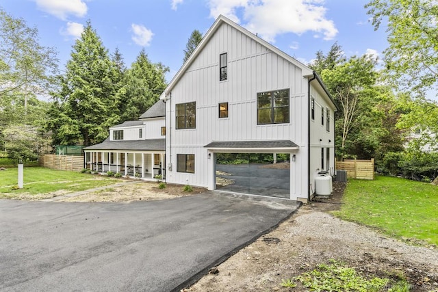 1207 Stillson Rd, Fairfield, CT 06824 - view of front of property featuring asphalt driveway, a carport, covered porch, and roof with shingles