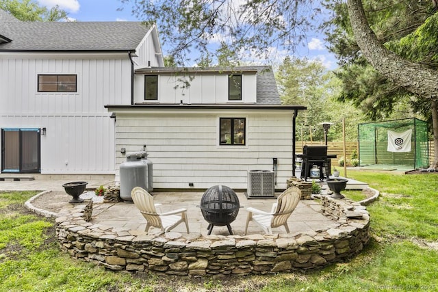 1207 Stillson Rd, Fairfield, CT 06824 - rear view of house featuring an outdoor fire pit, roof with shingles, a patio, and board and batten siding