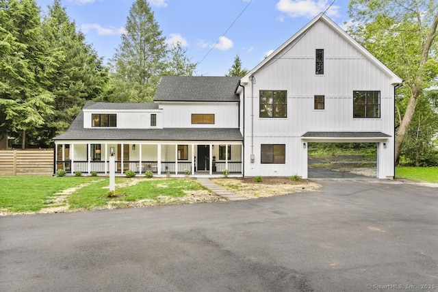 1207 Stillson Rd, Fairfield, CT 06824 - modern farmhouse featuring asphalt driveway, a porch, roof with shingles, and a carport