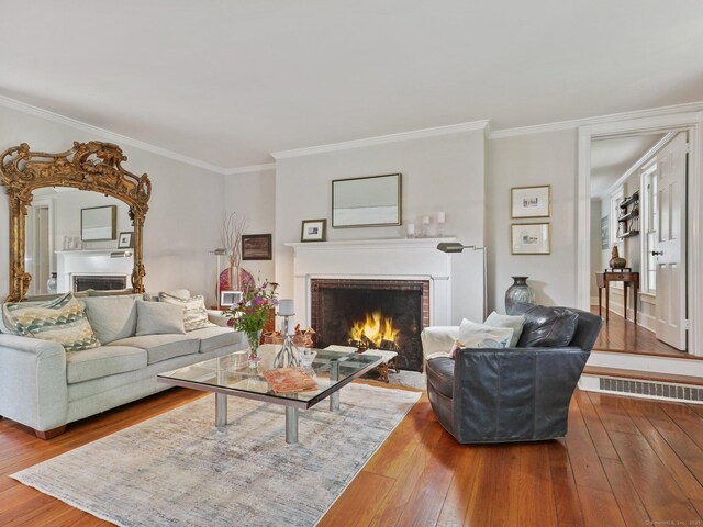 33 Great Pasture Rd, Redding, CT 06896 - living room with a brick fireplace, hardwood / wood-style flooring, and ornamental molding