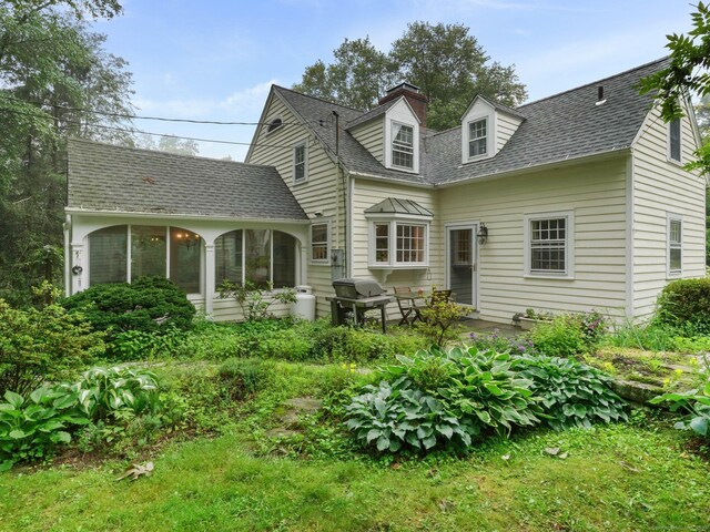 33 Great Pasture Rd, Redding, CT 06896 - rear view of house featuring a sunroom, roof with shingles, and a chimney