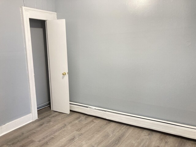 34 Park St, Bridgeport, CT 06608 - empty room featuring baseboard heating and wood finished floors