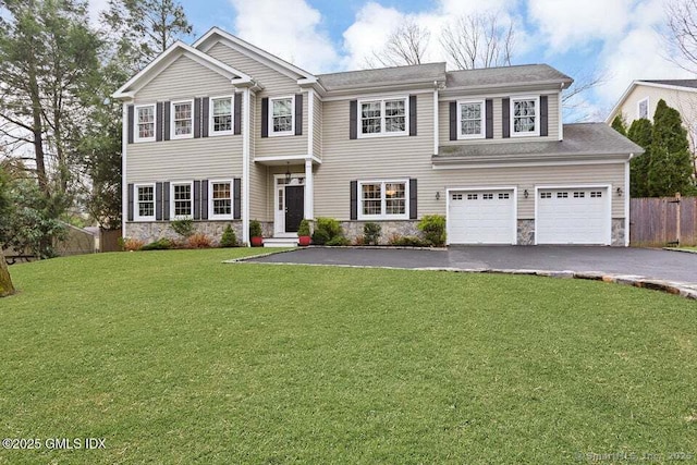 24 Nimitz Pl, Greenwich, CT 06870 - view of front of home featuring asphalt driveway, stone siding, and an attached garage