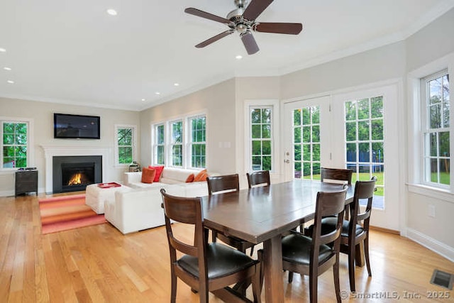 24 Nimitz Pl, Greenwich, CT 06870 - dining room featuring light wood-style floors, crown molding, recessed lighting, a fireplace with flush hearth, and ceiling fan