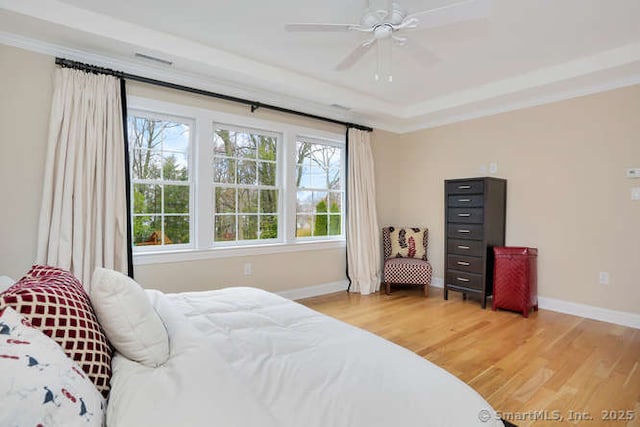 24 Nimitz Pl, Greenwich, CT 06870 - bedroom with light wood-style floors, a tray ceiling, and a ceiling fan