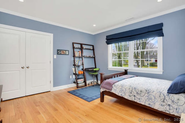 24 Nimitz Pl, Greenwich, CT 06870 - bedroom with wood finished floors, crown molding, recessed lighting, and a closet