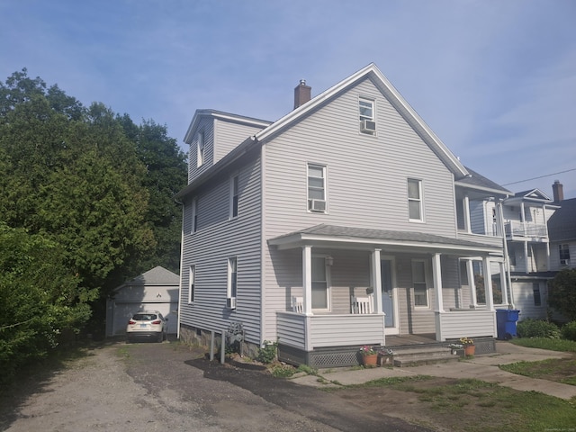 138 Harwinton Ave, Torrington, CT 06790 - view of front facade featuring a porch, a chimney, an outdoor structure, and a garage