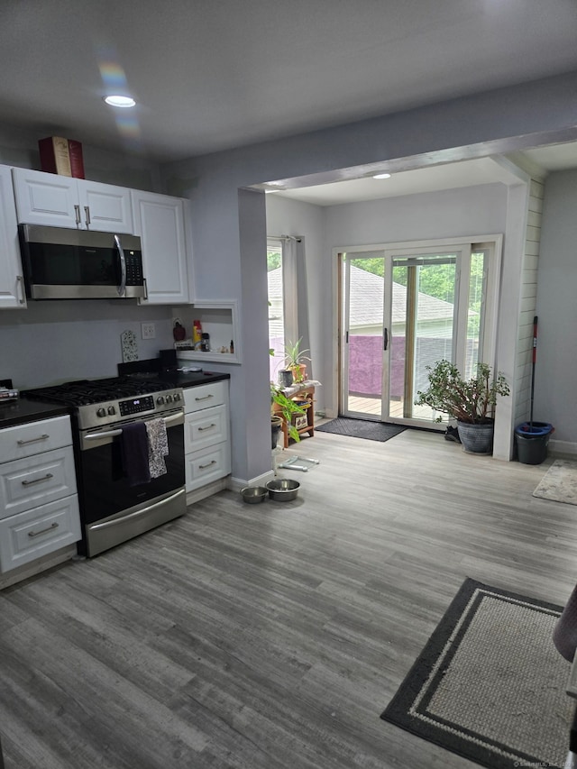 138 Harwinton Ave, Torrington, CT 06790 - kitchen featuring appliances with stainless steel finishes, white cabinets, dark countertops, wood finished floors, and recessed lighting