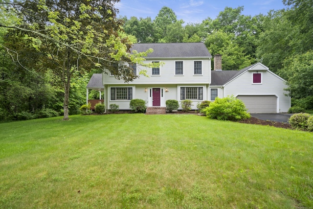 270 N Bride Brook Rd, East Lyme, CT 06333 - colonial home with asphalt driveway, a garage, a front yard, and a chimney