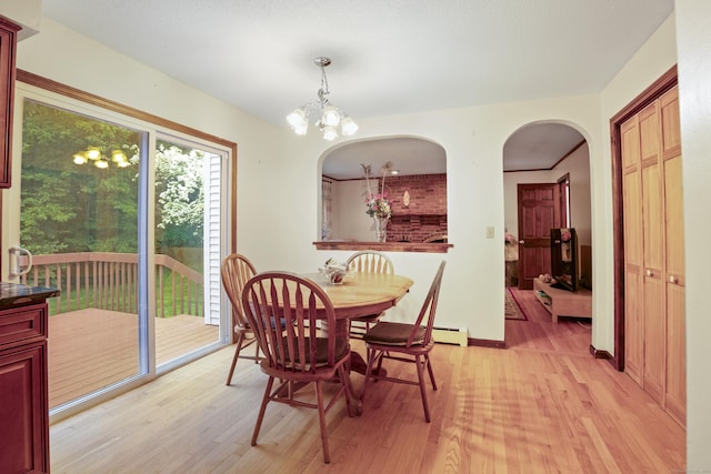270 N Bride Brook Rd, East Lyme, CT 06333 - dining area featuring light wood-style flooring, arched walkways, and a chandelier