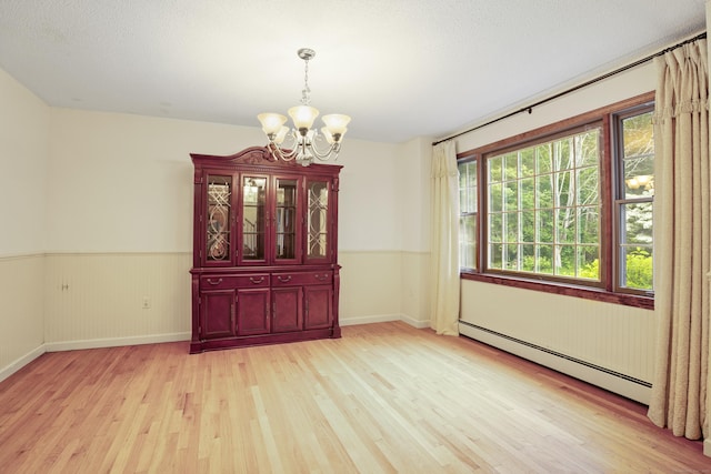 270 N Bride Brook Rd, East Lyme, CT 06333 - unfurnished room featuring a baseboard heating unit, a chandelier, light wood-style floors, and a wainscoted wall