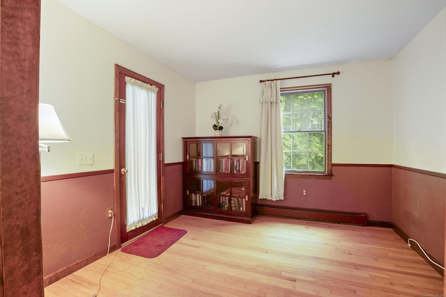 270 N Bride Brook Rd, East Lyme, CT 06333 - empty room with baseboard heating, a wainscoted wall, and wood finished floors