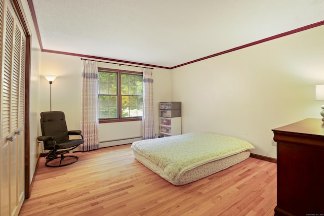 270 N Bride Brook Rd, East Lyme, CT 06333 - bedroom with baseboard heating, wood finished floors, and ornamental molding