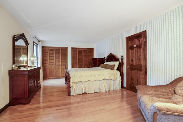 270 N Bride Brook Rd, East Lyme, CT 06333 - bedroom with light wood-style floors, multiple closets, wallpapered walls, and ornamental molding