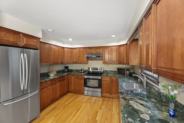 270 N Bride Brook Rd, East Lyme, CT 06333 - kitchen featuring stainless steel appliances, under cabinet range hood, light wood-style flooring, brown cabinetry, and recessed lighting