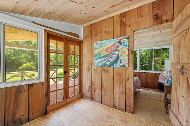 57 River Rd, Clinton, CT 06413 - doorway to outside with wooden walls, healthy amount of natural light, french doors, wood finished floors, and wooden ceiling