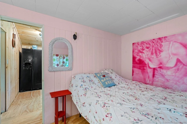 57 River Rd, Clinton, CT 06413 - bedroom with black fridge and wood walls