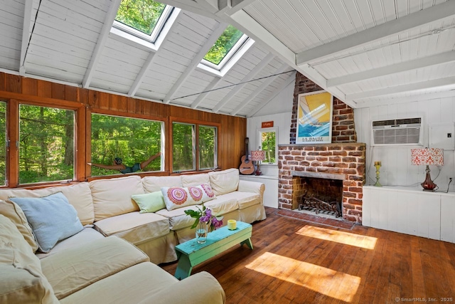 57 River Rd, Clinton, CT 06413 - living room with a wall mounted AC, a skylight, wood-type flooring, healthy amount of natural light, and wooden walls