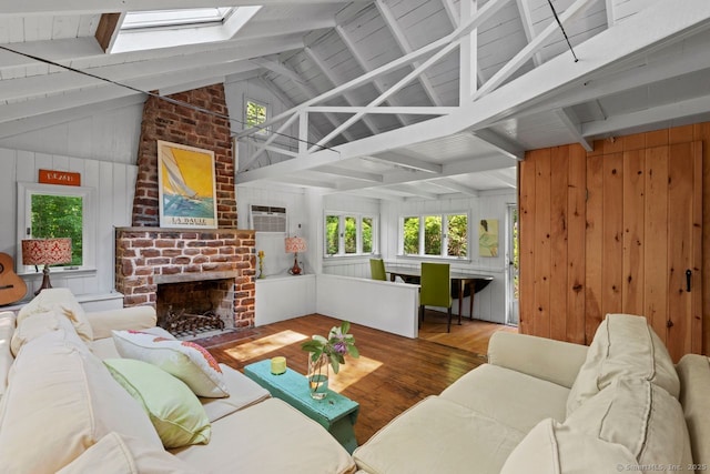 57 River Rd, Clinton, CT 06413 - living area with wood finished floors, a skylight, a fireplace, wood walls, and a wall mounted air conditioner
