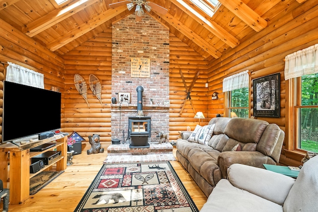 80 Jill Ln, Cheshire, CT 06410 - living room featuring a wood stove, a skylight, hardwood / wood-style floors, high vaulted ceiling, and a ceiling fan