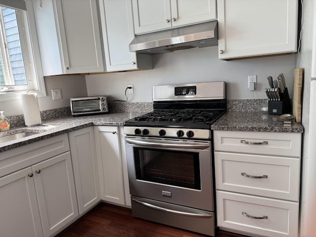 2480 Whitney Ave Unit 2, Hamden, CT 06518 - kitchen with stainless steel gas stove, under cabinet range hood, white cabinetry, and dark stone countertops
