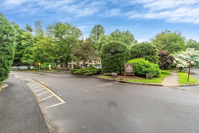 304 Foxwood Ln Unit 304, Milford, CT 06461 - view of asphalt road with curbs, traffic signs, and sidewalks