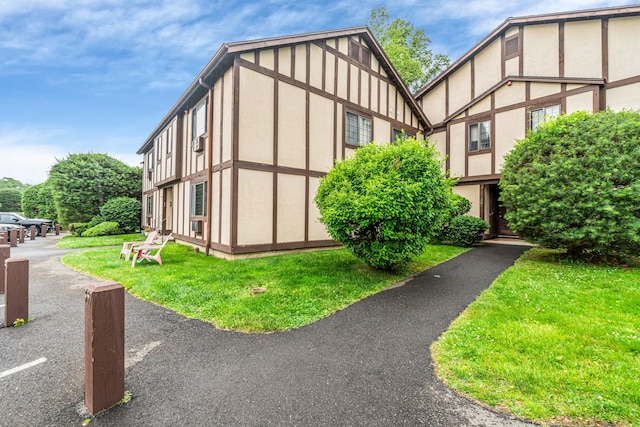 304 Foxwood Ln Unit 304, Milford, CT 06461 - view of property exterior featuring a lawn