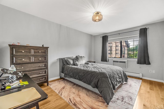 304 Foxwood Ln Unit 304, Milford, CT 06461 - bedroom featuring a baseboard heating unit and light wood-style flooring