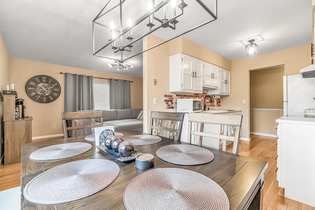 304 Foxwood Ln Unit 304, Milford, CT 06461 - dining area with light wood finished floors and a chandelier