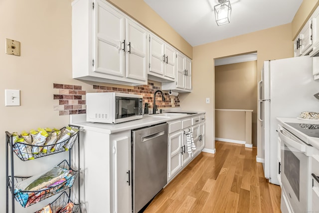 304 Foxwood Ln Unit 304, Milford, CT 06461 - kitchen with stainless steel dishwasher, white range with electric stovetop, light countertops, decorative backsplash, and white cabinets