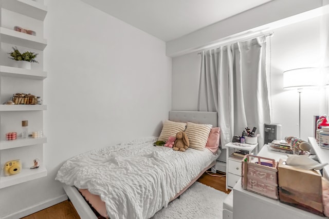 304 Foxwood Ln Unit 304, Milford, CT 06461 - bedroom with light wood finished floors and a baseboard heating unit