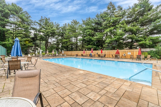 304 Foxwood Ln Unit 304, Milford, CT 06461 - community pool with a patio area, view of scattered trees, and outdoor dining area
