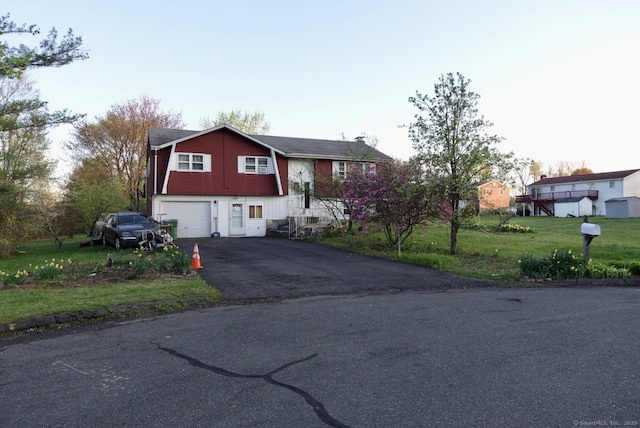 11 Kenneth Cir, Windsor, CT 06095 - split foyer home with asphalt driveway, a garage, and a front lawn