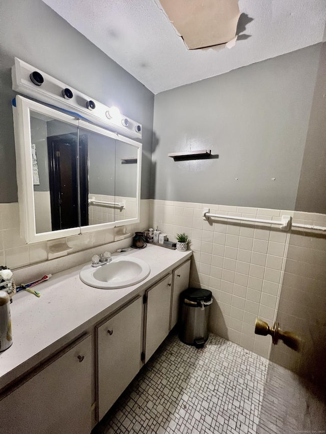 11 Kenneth Cir, Windsor, CT 06095 - bathroom featuring vanity, tile walls, a wainscoted wall, tile patterned floors, and a textured ceiling