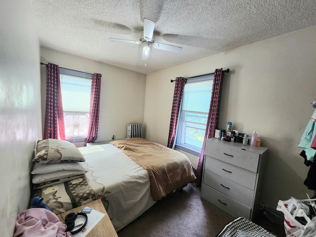 8 Park Ave, Enfield, CT 06082 - bedroom with a textured ceiling, radiator heating unit, a ceiling fan, and dark carpet