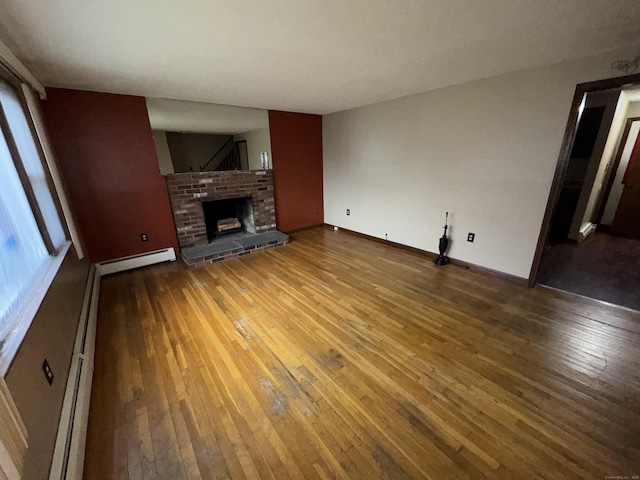 829 Windsor Ave, Windsor, CT 06095 - unfurnished living room with hardwood / wood-style flooring, a fireplace, and baseboard heating