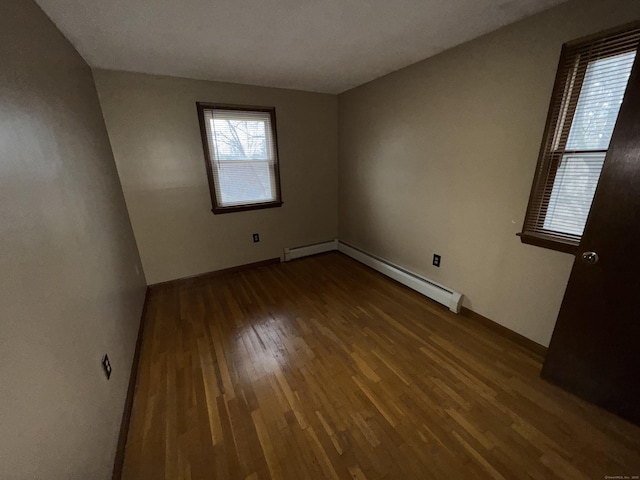829 Windsor Ave, Windsor, CT 06095 - empty room featuring a baseboard heating unit, wood finished floors, and baseboard heating