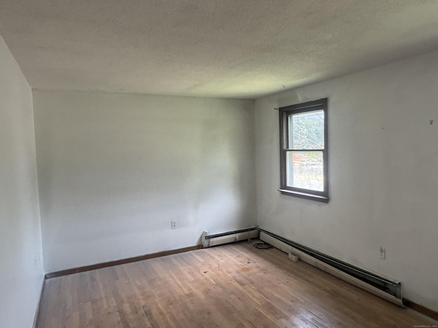 829 Windsor Ave, Windsor, CT 06095 - spare room with wood finished floors, a baseboard radiator, and a textured ceiling
