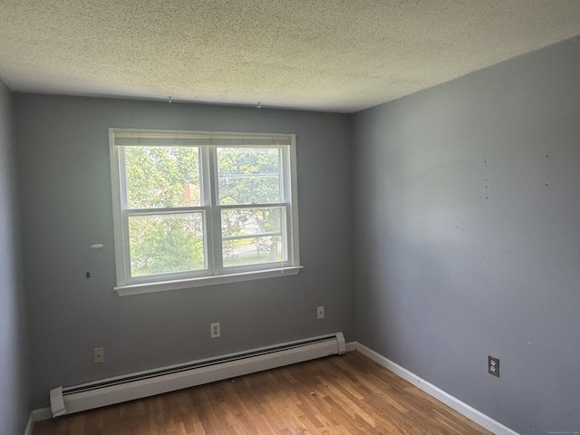 829 Windsor Ave, Windsor, CT 06095 - unfurnished room with a baseboard heating unit, a textured ceiling, and wood finished floors